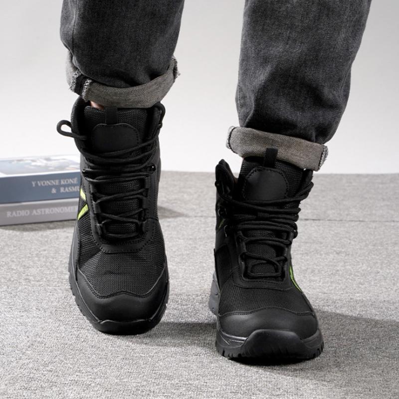 Schwarze High-Tops am Fuß, Industrieboden – Vorderansicht