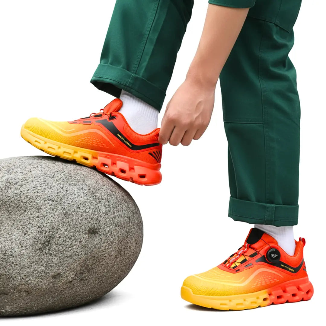 Leichte Sicherheitsschuhe in Orange und Gelb auf Felsen – ideal für lange Arbeitstage